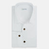 View 5 of product The White Hyde Overshirt by Turnbull & Asser is crafted from sanforised cotton with a left chest pocket and dark buttons—offering a sharp, casual blazer alternative. Shown laid flat on a white background.