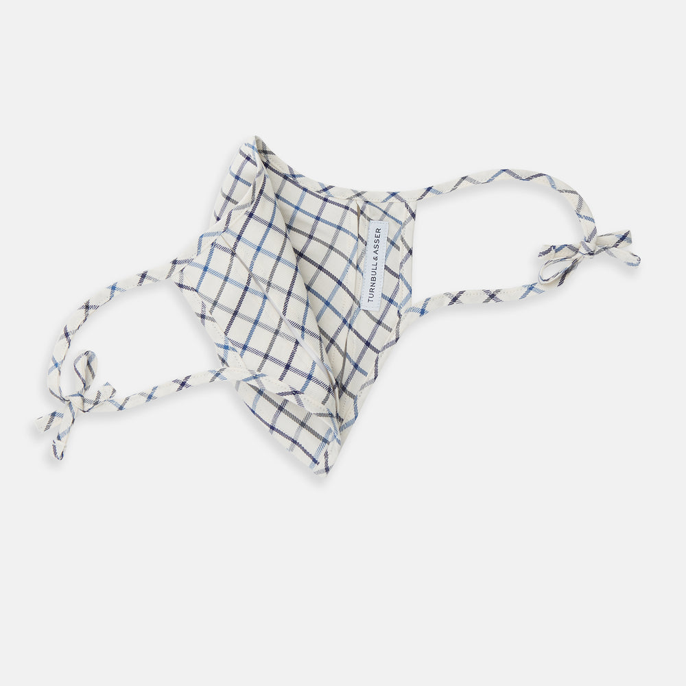 The Turnbull & Asser Check Blue Multi Commuter Mask features a blue plaid design, adjustable fabric ear loops tied in bows, and comes with 3 Viroformula™ filters. Laid flat on a white background.