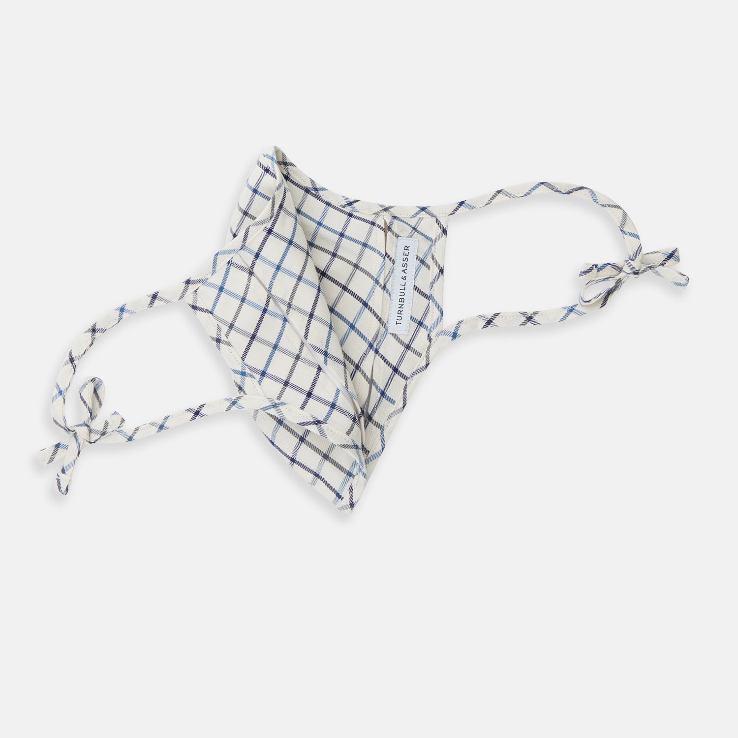 View 5 of product The Turnbull & Asser Check Blue Multi Commuter Mask features a blue plaid design, adjustable fabric ear loops tied in bows, and comes with 3 Viroformula™ filters. Laid flat on a white background.