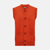 View 1 of product The Turnbull & Asser Red Orange Cashmere Sleeveless Cardigan features a ribbed collar, hem, and armholes, button-down front, and two front pockets—perfect as a refined light layer, shown against a white background.
