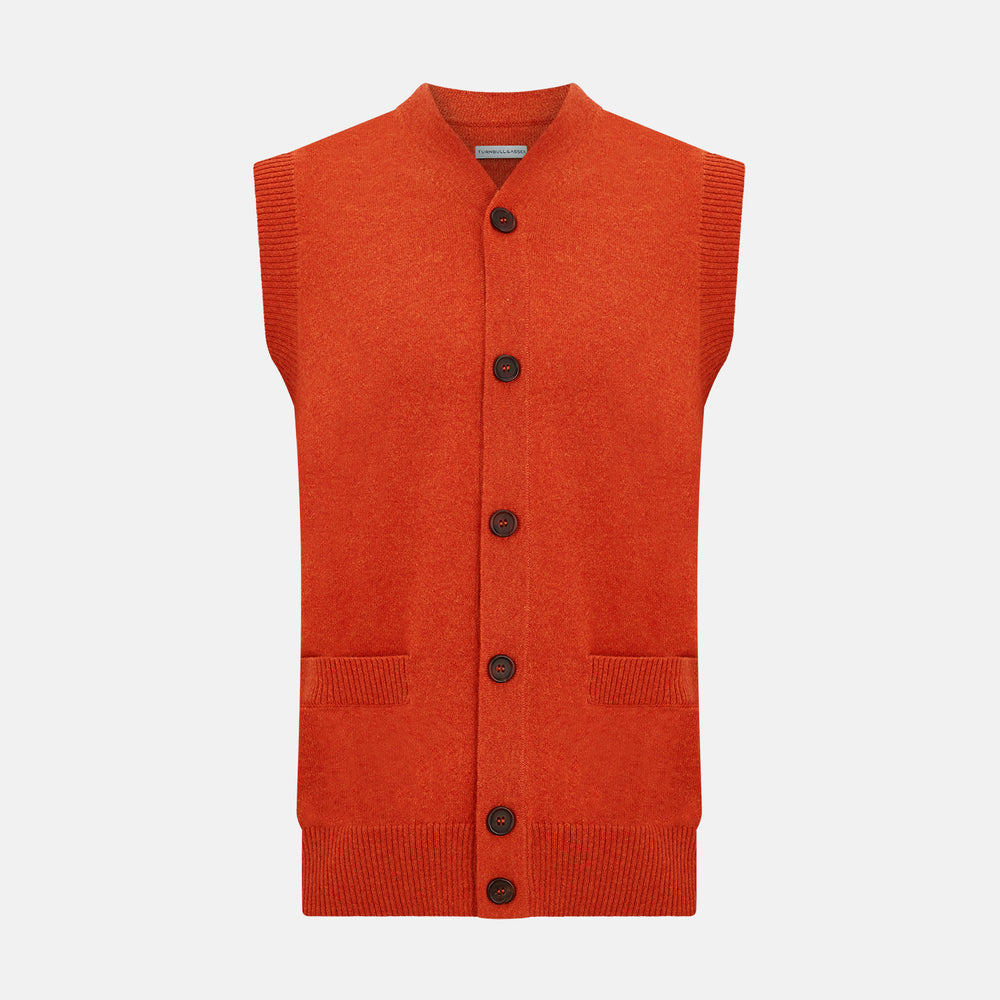 The Turnbull & Asser Red Orange Cashmere Sleeveless Cardigan features a ribbed collar, hem, and armholes, button-down front, and two front pockets—perfect as a refined light layer, shown against a white background.