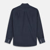 View 5 of product The Turnbull & Asser Navy Weekend Fit Larkin Shirt features a Dorset collar, long sleeves with 3-button cuffs, two chest pockets, and white snaps, shown laid flat against a white background.
