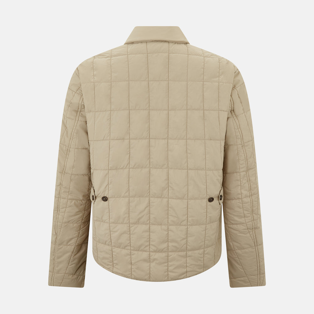 The Battersea Sand Quilted Jacket by Turnbull & Asser is a light beige men's jacket with a front zipper, pointed collar, zippered side pockets, chest pocket, and buttoned cuffs, shown on a plain white background.
