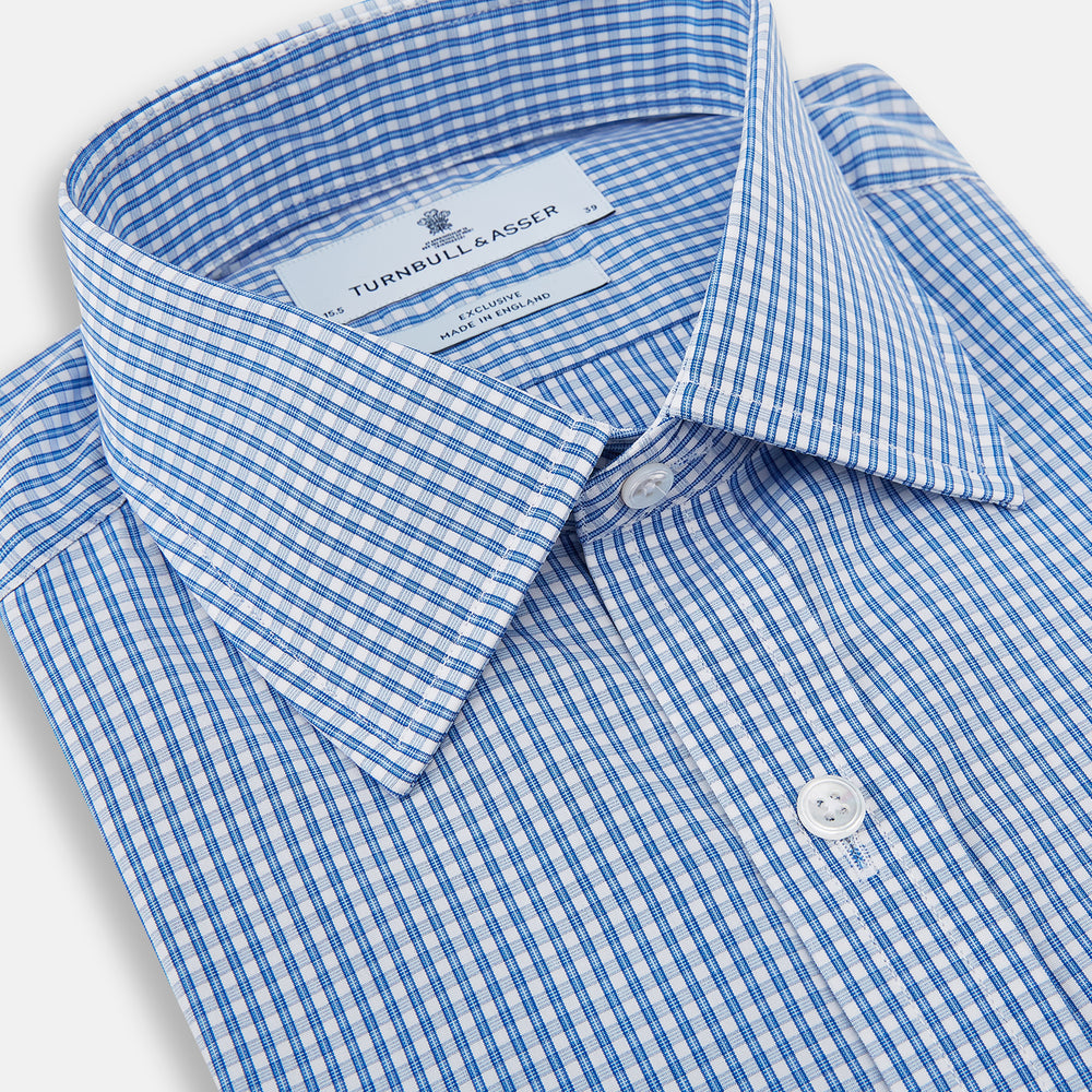 The Turnbull & Asser Blue Multi Micro Check Mayfair Shirt features a classic T&A collar, button-up front, white buttons, cuffed long sleeves, and a refined light blue and white micro check pattern.