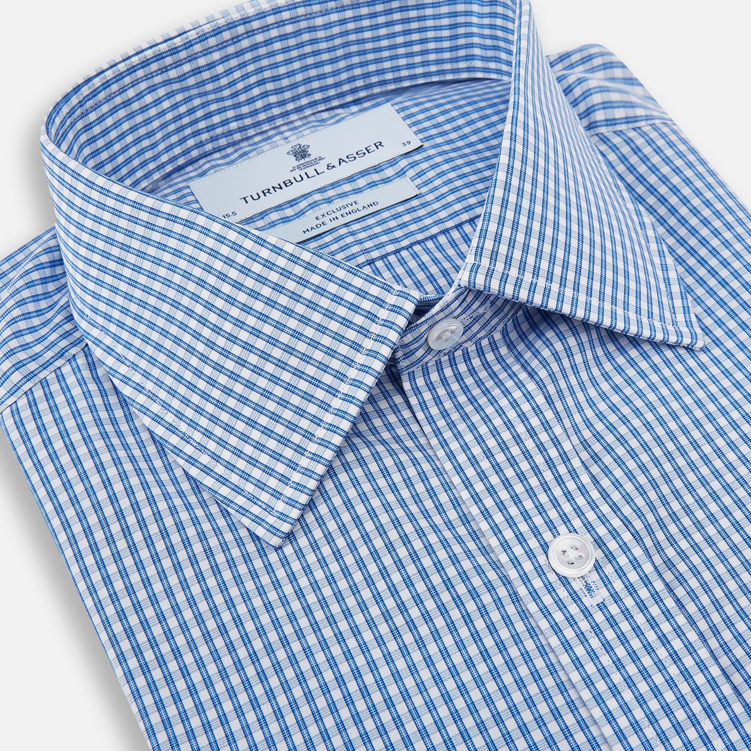 View 2 of product The Turnbull & Asser Blue Multi Micro Check Mayfair Shirt features a classic T&A collar, button-up front, white buttons, cuffed long sleeves, and a refined light blue and white micro check pattern.