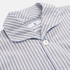 View 4 of product The Turnbull & Asser Pale Blue Multi Stripe Cotton Quin Pyjamas, featuring a long-sleeve button-up top and matching adjustable tie-waist pants, are neatly arranged on a white background.