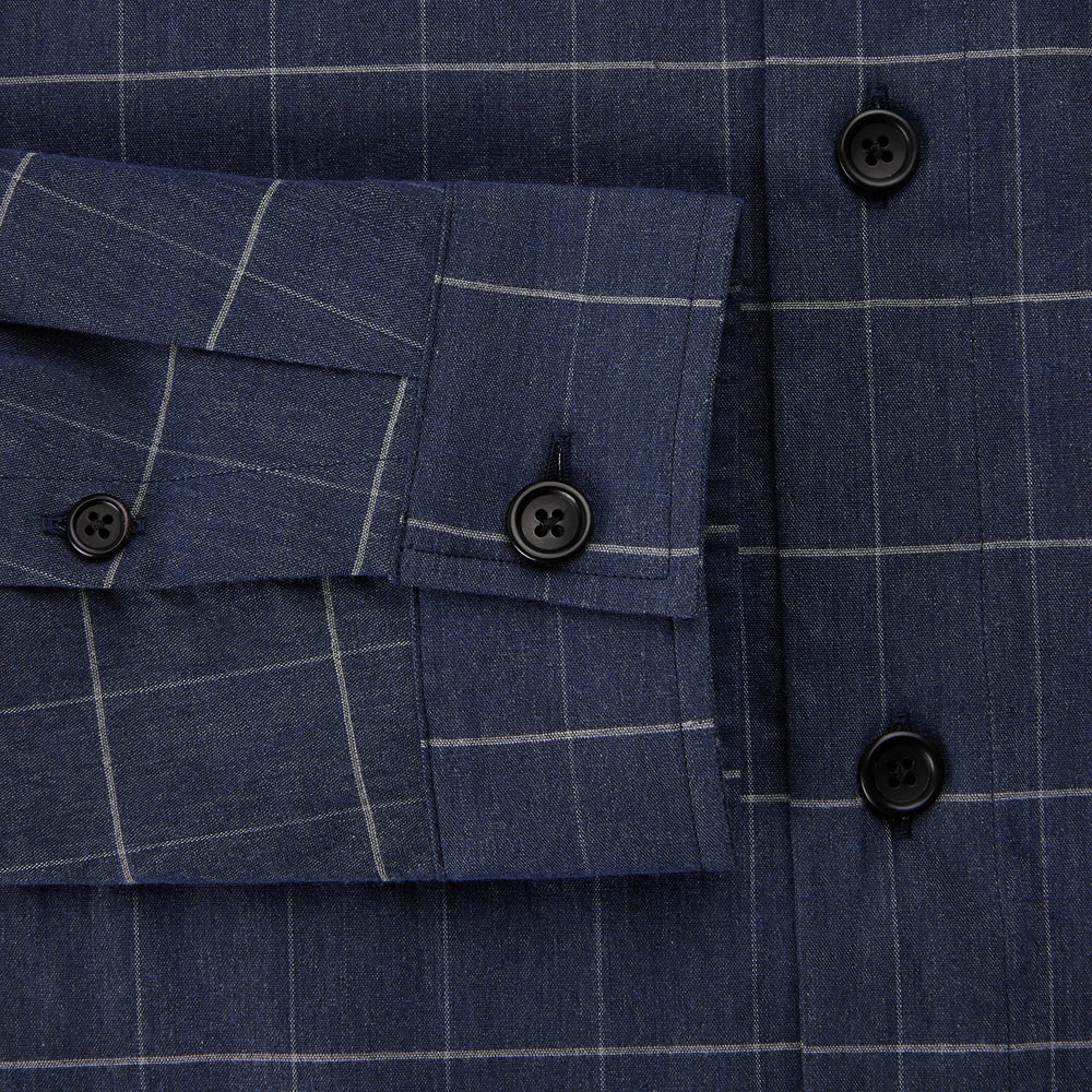 The Turnbull & Asser Royal Blue Check Hampstead Overshirt features a white windowpane pattern, long sleeves, two front pockets, and a chest pocket, displayed on a plain white background for an elegant classic look.