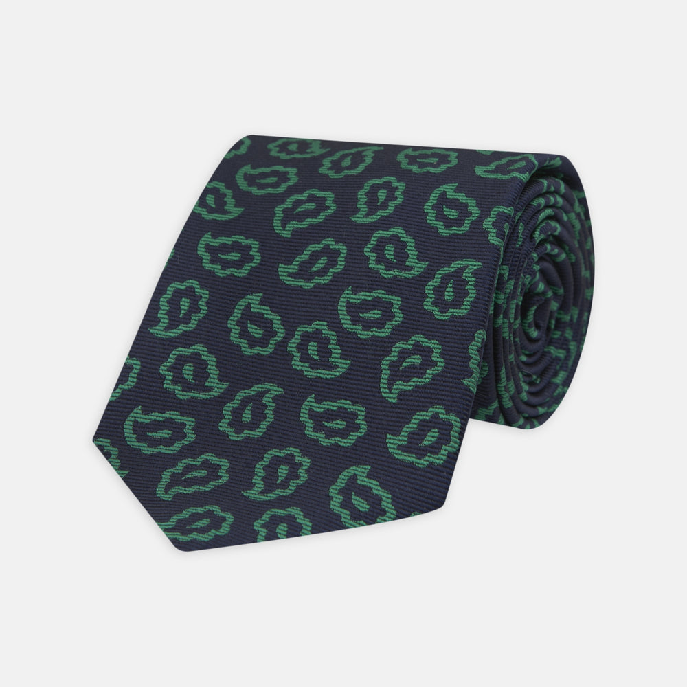 The Turnbull & Asser Navy and Green Petal Paisley Silk Tie is a stylish accessory, featuring timeless paisley motifs on silk, making it an elegant addition to any wardrobe.