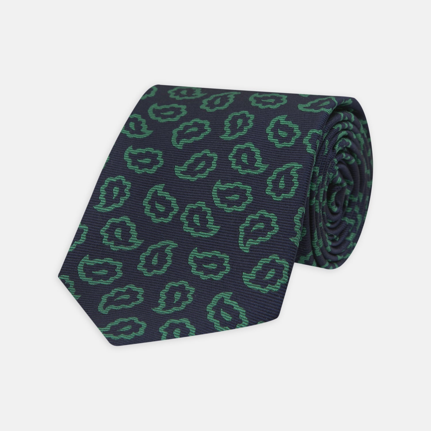 View 1 of product The Turnbull & Asser Navy and Green Petal Paisley Silk Tie is a stylish accessory, featuring timeless paisley motifs on silk, making it an elegant addition to any wardrobe.