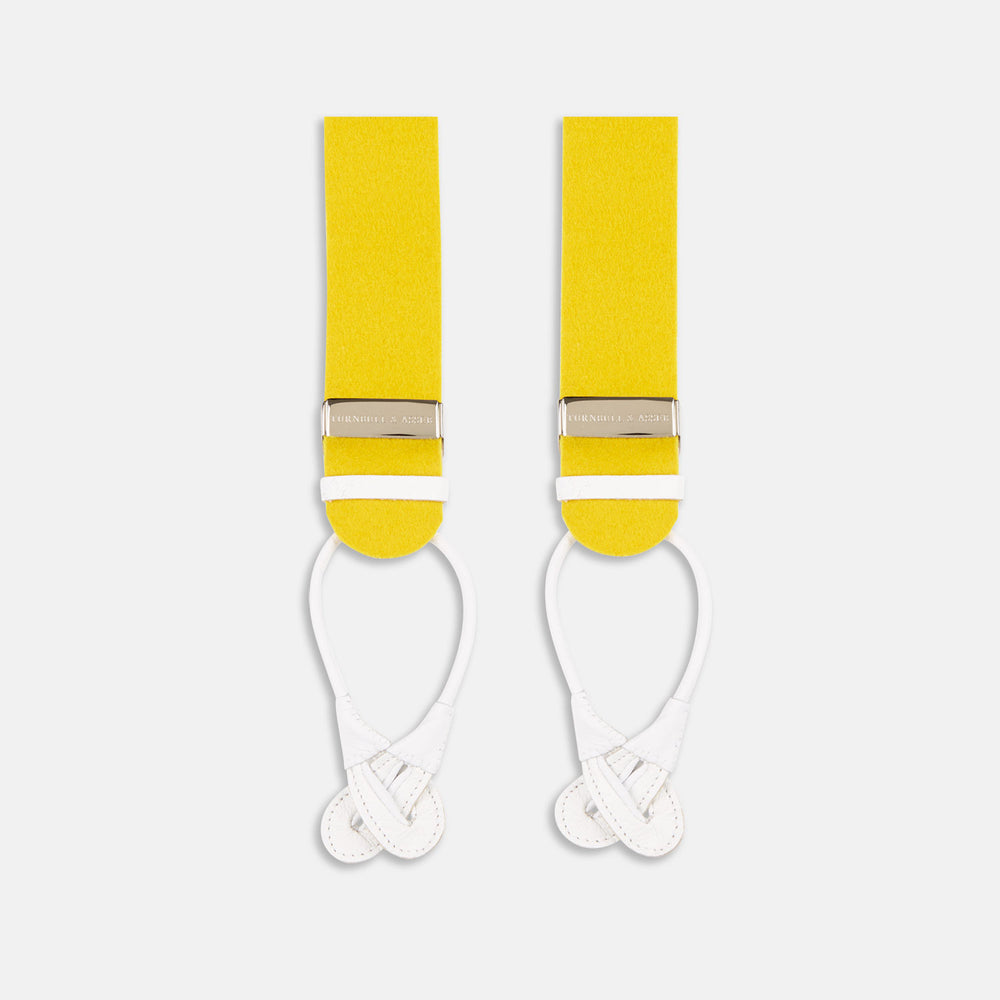 The Turnbull & Asser Golden Adjustable Felt Braces feature yellow elastic, silver metal clips, and white leather loops, evoking classic English style. Shown against a white backdrop.