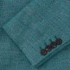 View 3 of product A man with short brown hair and a neutral expression stands against a plain background, wearing a Teal Linen Barrington Blazer by Turnbull & Asser, a light pink dress shirt, white trousers, brown loafers, and a patterned pocket square.