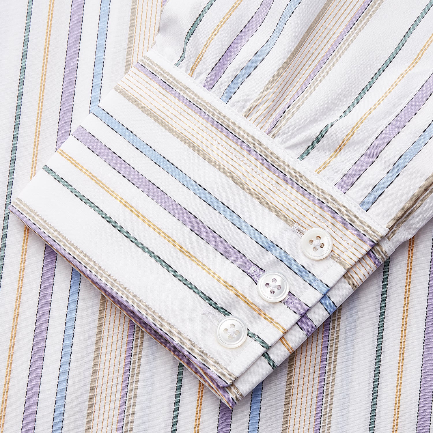 View 4 of product The Colourful Garden Multi Stripe Cotton Regular Fit Mayfair Shirt by Turnbull & Asser features a collar, buttoned cuffs, and vertical stripes in blue, yellow, pink, and white on a light background for a relaxed look.