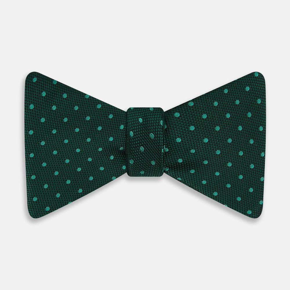 The Turnbull & Asser Turquoise and Forest Green Micro Dot Silk Bow Tie features small light green spots on a dark background, offering a stylish accessory for any occasion.