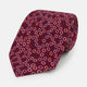 The Turnbull & Asser Pink and Navy Circle Burgundy Silk Tie features a rolled burgundy silk design with small, evenly spaced white, pink, and light blue circle patterns.