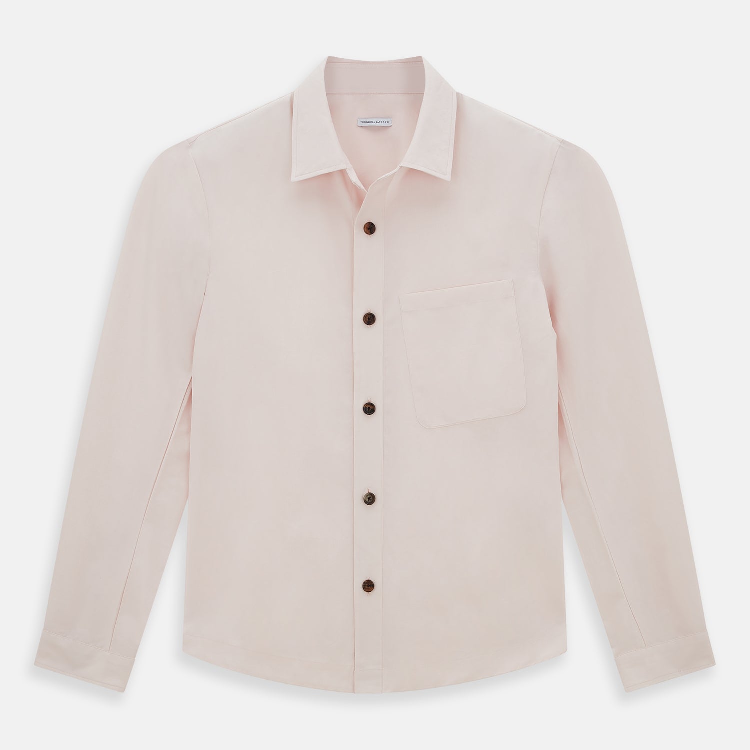 View 1 of product The Turnbull & Asser Pale Pink Hyde Overshirt is a long-sleeve, sanforised cotton button-up with a left chest pocket and dark buttons, shown laid flat on a white background.