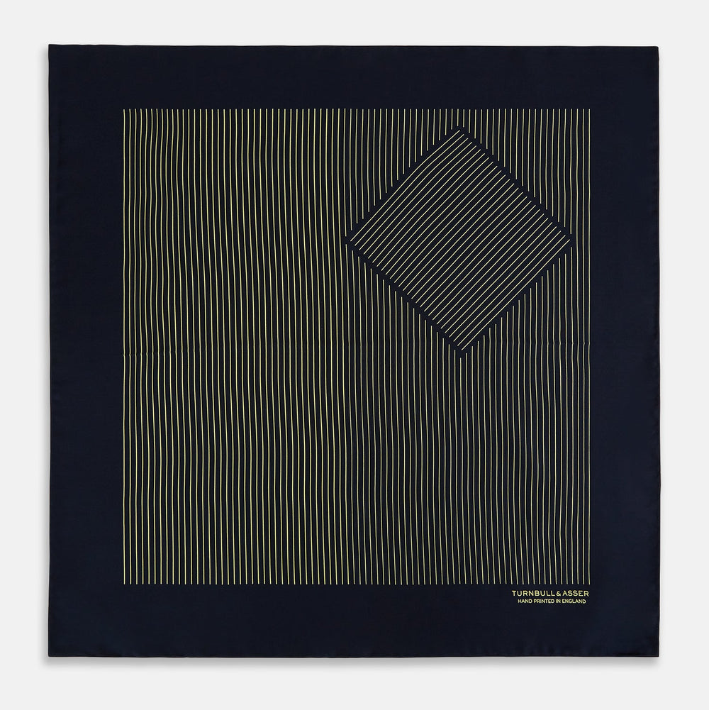 The Turnbull & Asser Navy and Gold Stripe Silk Pocket Square features light yellow vertical stripes, a folded corner, and "TURNBULL & ASSER HAND PRINTED IN ENGLAND" in gold at the bottom right.
