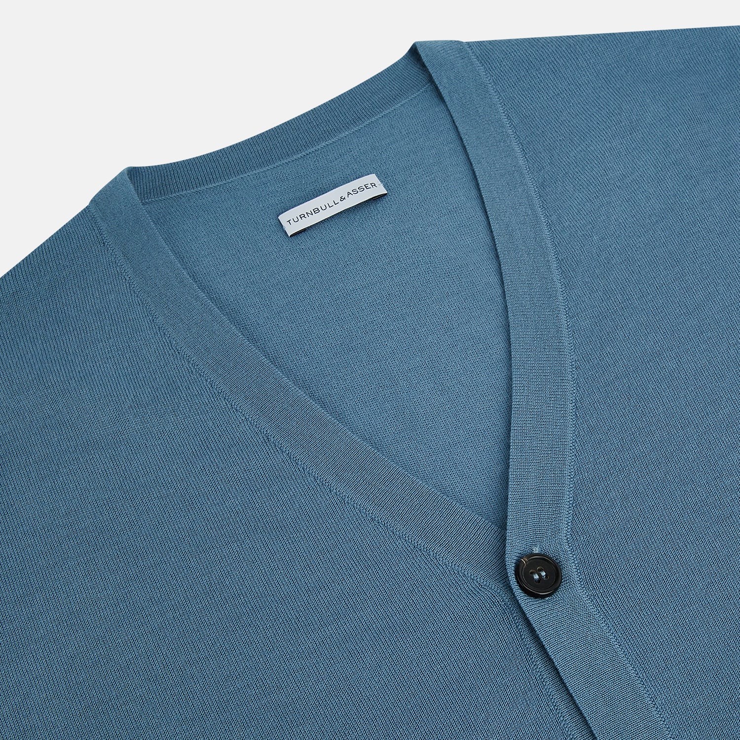 View 2 of product The Turnbull & Asser Pale Blue Fine Merino V-Neck Cardigan features long sleeves and five black buttons, showcased on a plain white background.
