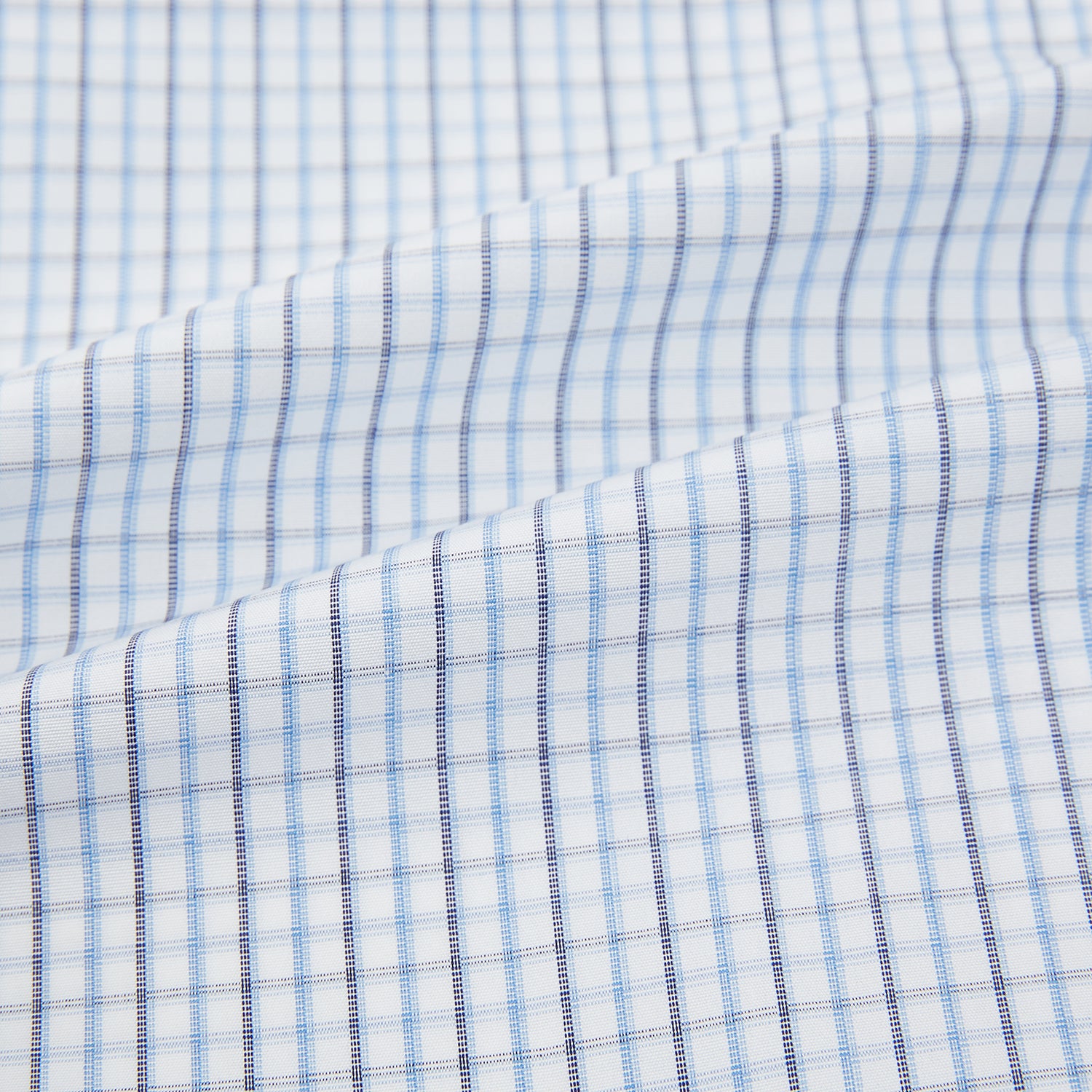 View 6 of product The Turnbull & Asser Navy and Blue Multi Check Mayfair Shirt features a T&A collar, button cuffs, and a blue checkered pattern. This long-sleeve, button-up shirt is shown on a white background.