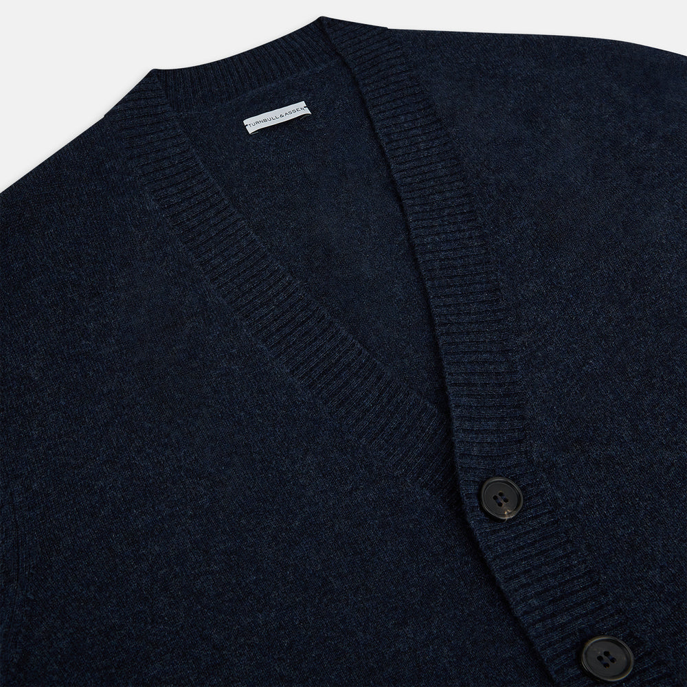 The Navy Melange Cashmere Cardigan by Turnbull & Asser features long sleeves, a V-neck, five dark buttons, ribbed cuffs and hem, and two front pockets. Shown against a plain white background.