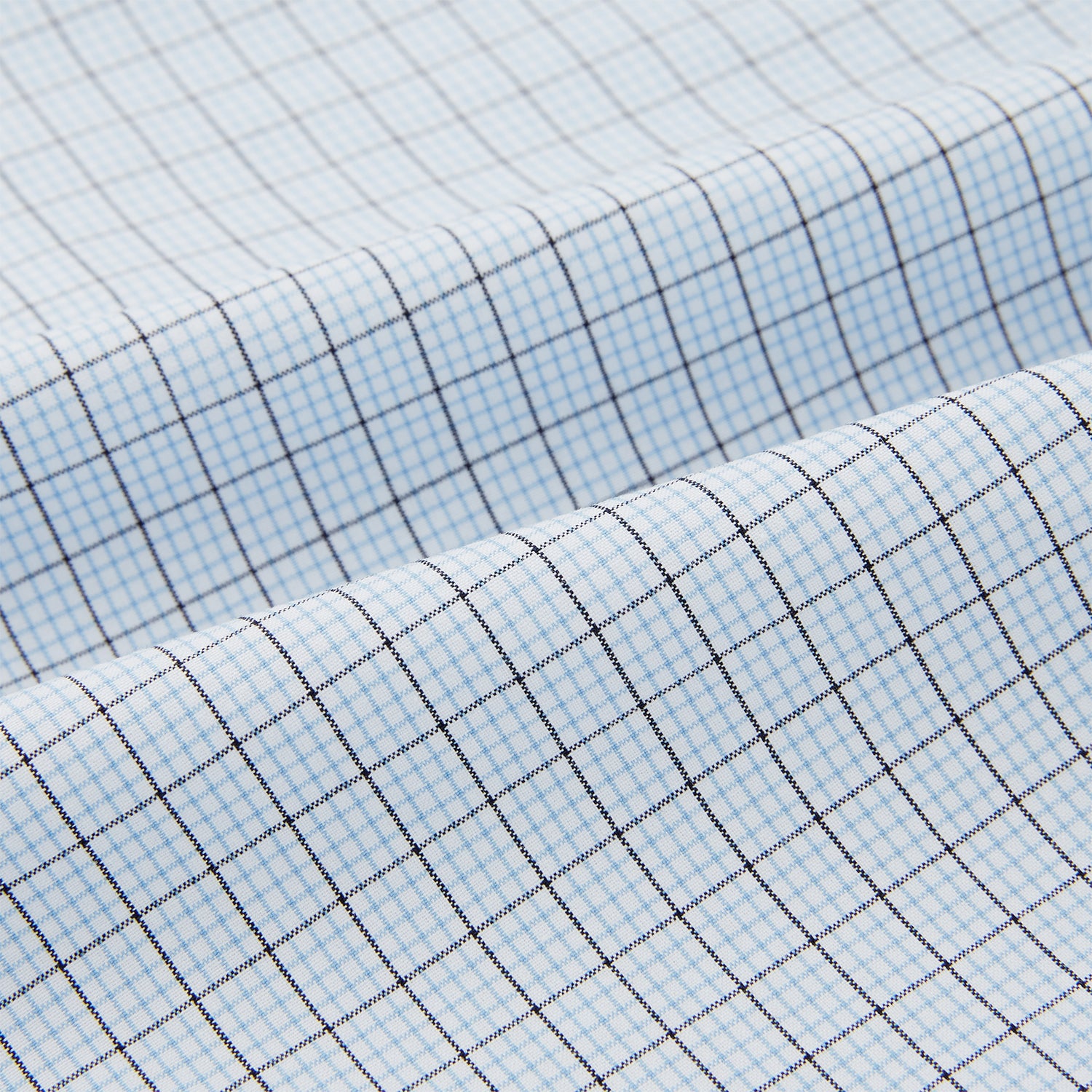 View 6 of product The Turnbull & Asser Blue Graph Check Pyjama Shirt features long sleeves, a collar, and a small check pattern in light blue—ideal as elegant loungewear.