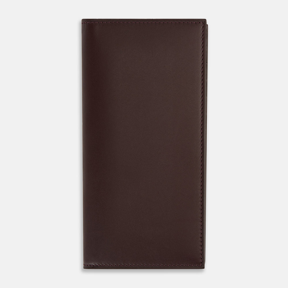 The Turnbull & Asser Burgundy B Cut Continental Wallet, with smooth, unadorned surfaces and visible edge stitching, is pictured closed in rich burgundy Italian leather against a white background.