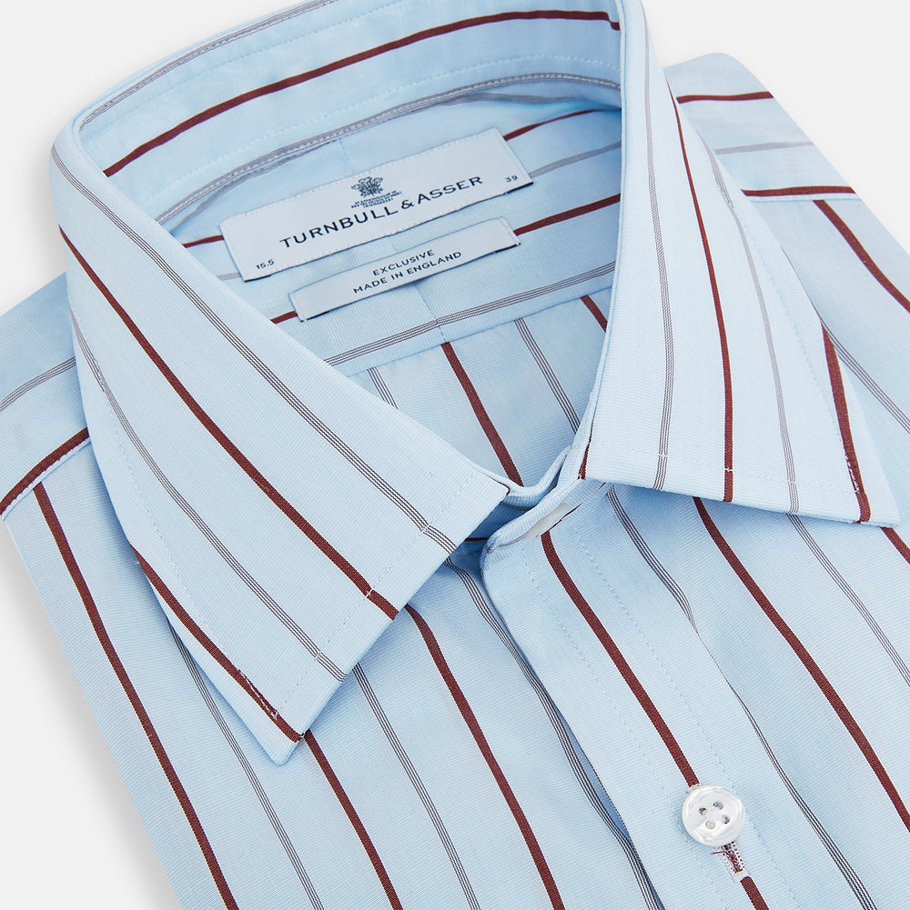 The Turnbull & Asser Burgundy Wide Pinstripe Mayfair Shirt features a collared, long-sleeve design with bold vertical stripes, crafted in the refined Mayfair fit and displayed on a plain white background.