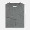 View 4 of product The Turnbull & Asser Grey Melange Cashmere Round Neck Jumper for men features a classic crewneck design with ribbed cuffs, hem, and neckline, displayed against a white background.