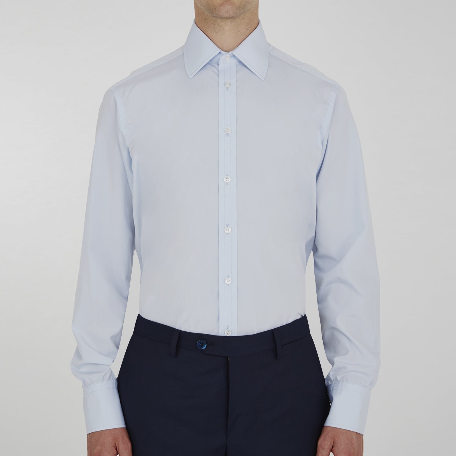 View 5 of product The Turnbull & Asser Two-Fold 120 Light Blue Shirt features a T&A collar, 3-button cuffs, white buttons, front pocket, and inner collar label. It is displayed neatly folded on a plain white background.