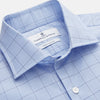 View 2 of product The Blue Prince of Wales Check Mayfair Shirt by Turnbull & Asser features a light blue check pattern, white buttons, and a classic collar. Crafted from premium Italian cotton, it is displayed on a plain white background.