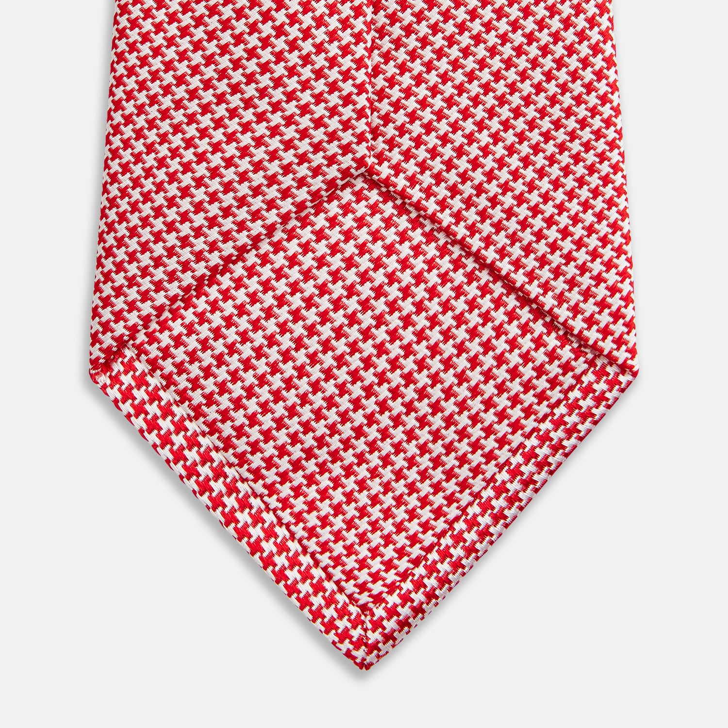 View 4 of product The HOUNDSTOOTH WHITE TULIP RED TIE by Turnbull & Asser features a refined red and white houndstooth pattern—an elegant accessory that elevates any crisp shirt or formal look.