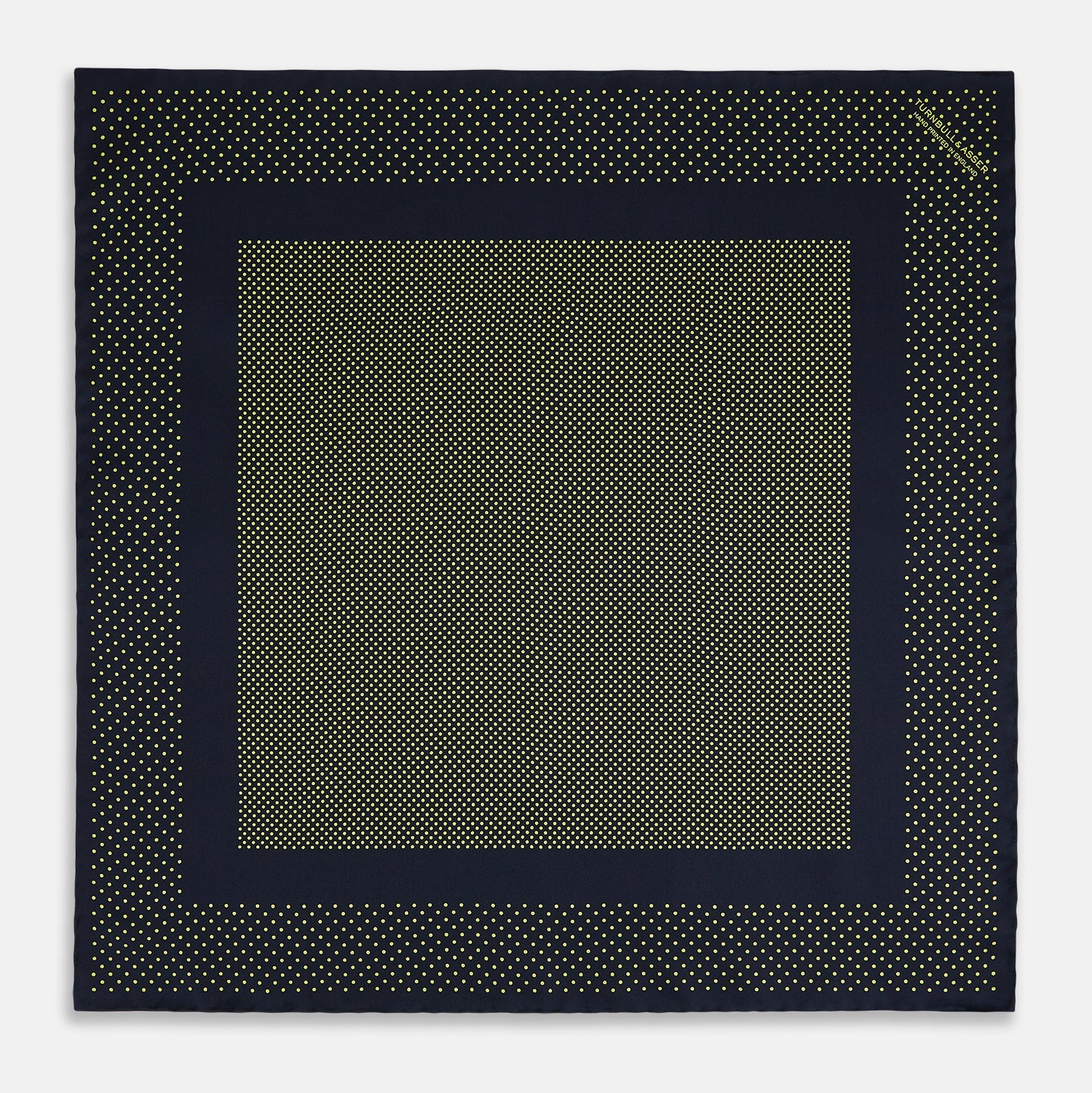 View 4 of product The Turnbull & Asser Navy and Yellow Dot Silk Pocket Square features a navy base with yellow dots, a solid navy border, and a folded corner showing the patterned underside for an elegant accent.
