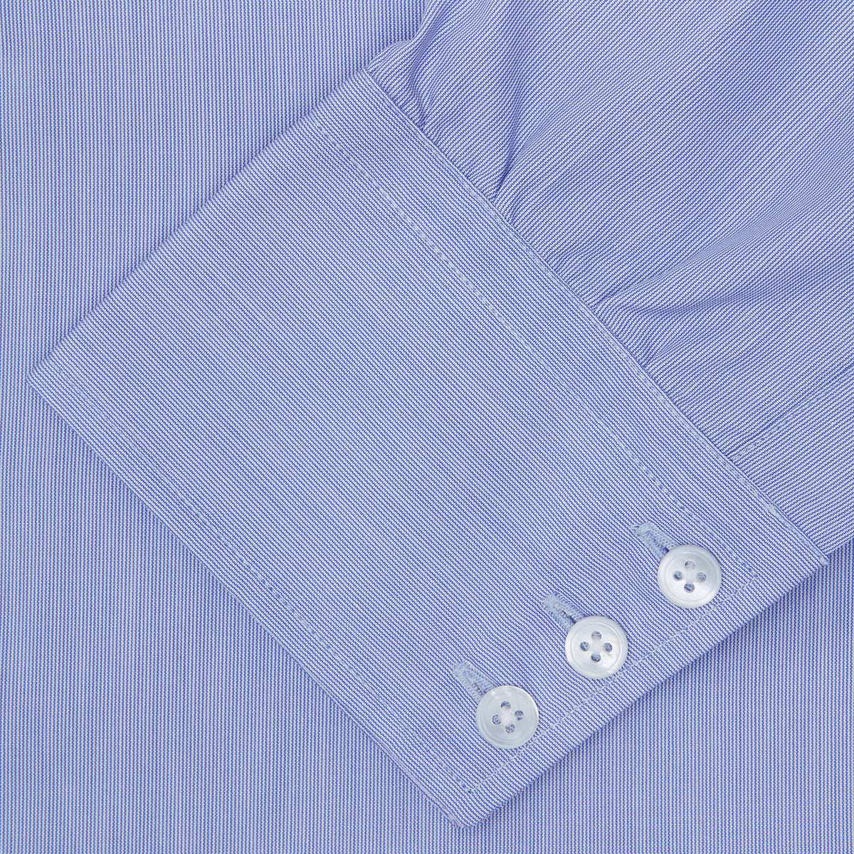 View 6 of product The Turnbull & Asser Blue Hairline Stripe Shirt features a T&A collar, 3-button cuffs, and subtle stripes, displayed neatly folded against a plain white background.