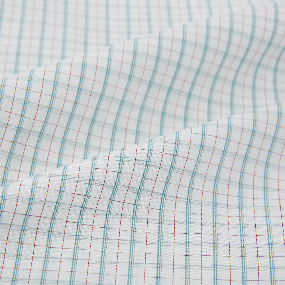 The Turnbull & Asser Turquoise and Red Multi Check Westminster shirt features long sleeves, a standard collar, and buttoned cuffs, showcasing fine British craftsmanship. It’s pictured laid flat on a white background.