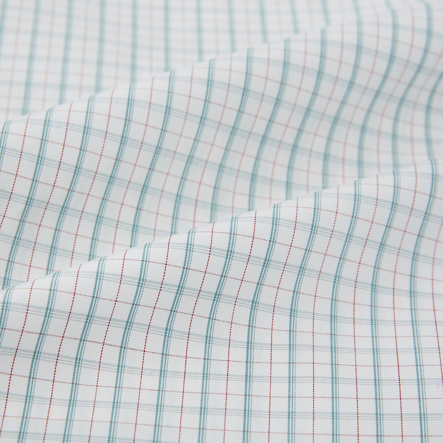 View 8 of product The Turnbull & Asser Turquoise and Red Multi Check Westminster shirt features long sleeves, a standard collar, and buttoned cuffs, showcasing fine British craftsmanship. It’s pictured laid flat on a white background.