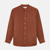 View 1 of product The Turnbull & Asser Rust Cotton Weekend Fit Blake Shirt features long sleeves, a stand collar, and white buttons—an ideal casual piece displayed flat on a white background.