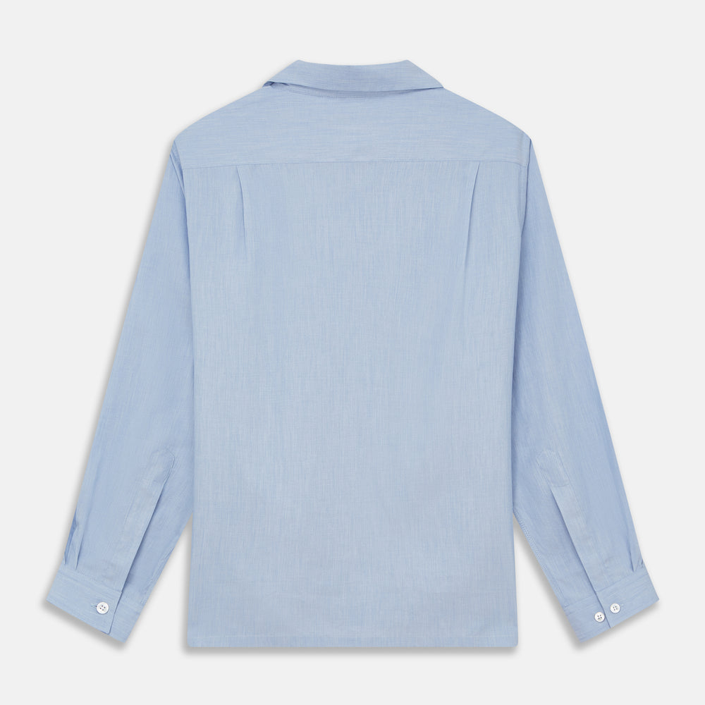 The Turnbull & Asser Slate Blue Chambray Holiday Fit Fellows Shirt features long sleeves and a classic collar, laid flat on a white background—a versatile summer piece for any occasion.