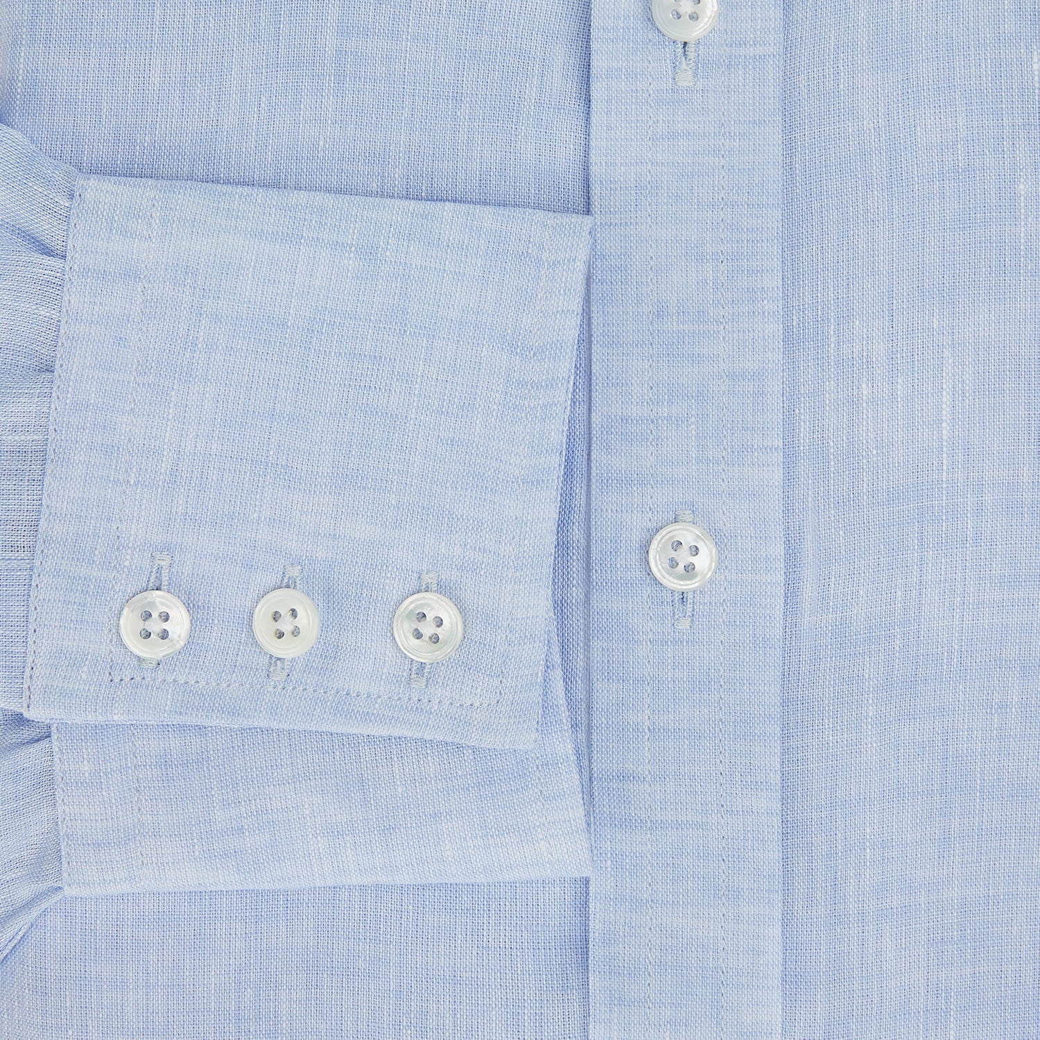 View 4 of product The Turnbull & Asser PALE BLUE LINEN MAYFAIR SHIRT features long sleeves, a classic collar, and lightweight linen fabric in a refined Mayfair fit, shown on a white background.