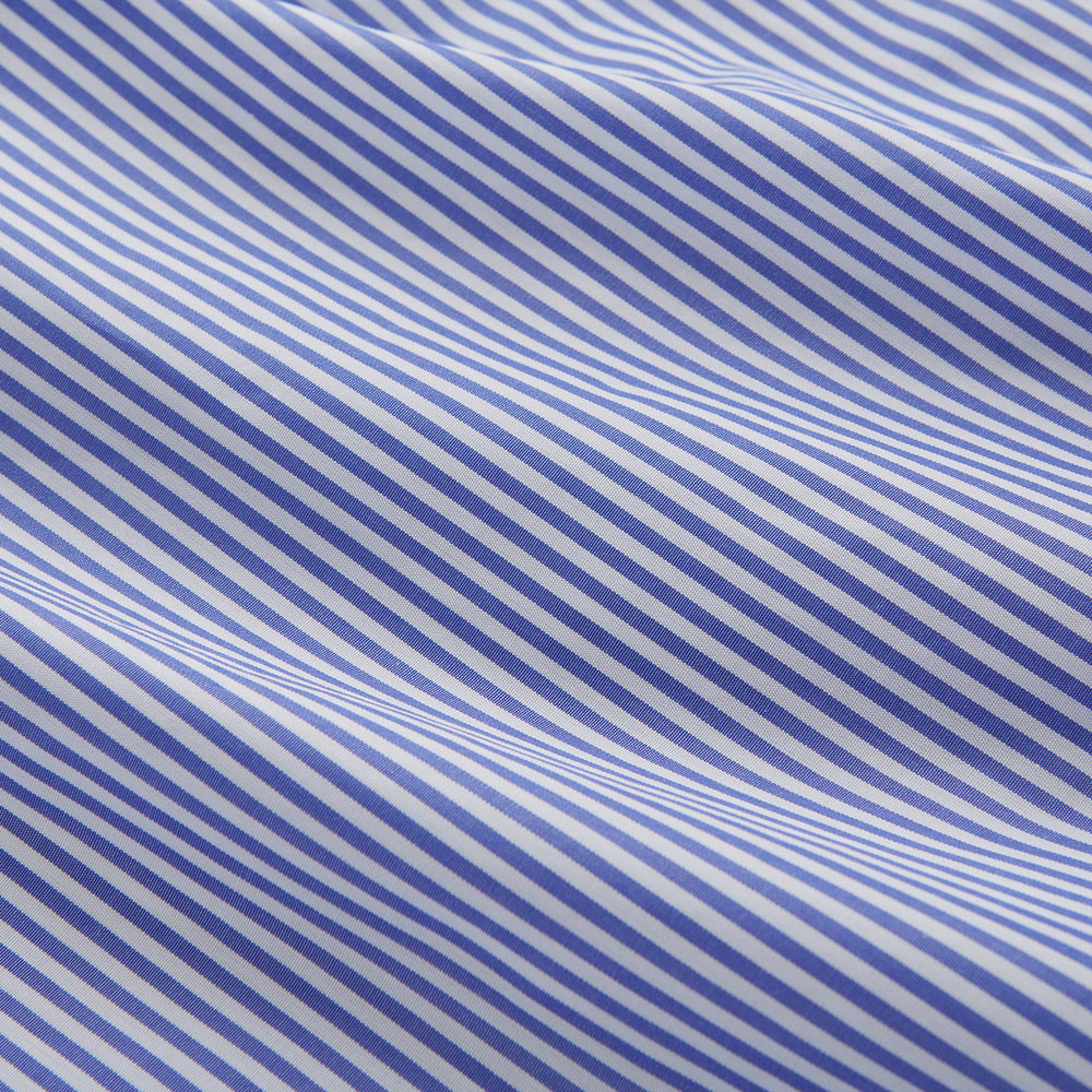 The Turnbull & Asser Women's Harriet Blue Bengal Stripe Pyjama Set features premium cotton, a long-sleeve button-up top with chest pocket, and drawstring pants—an ideal gift option.