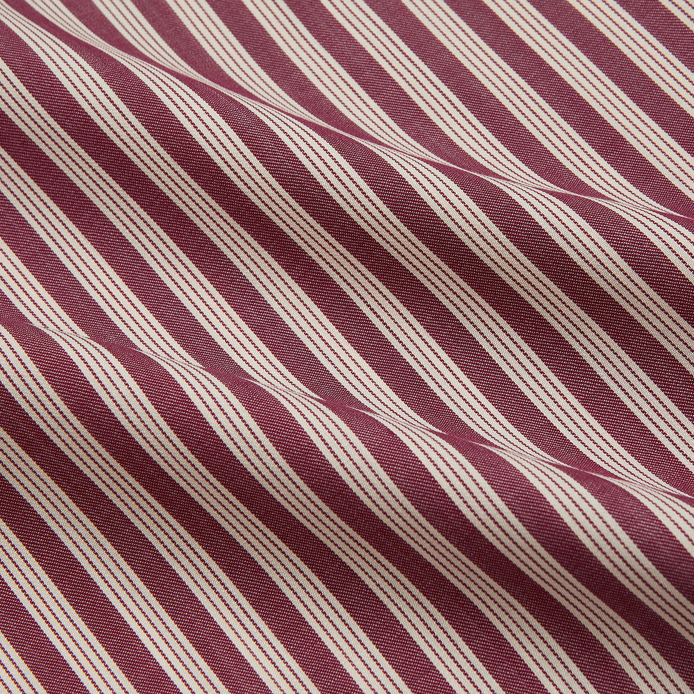 The Turnbull & Asser Burgundy Multi Stripe Weekend Fit Wool Shirt features a Derby collar, 1 button cuffs, and vertical red and white stripes, ideal for casual wear, shown against a white background.
