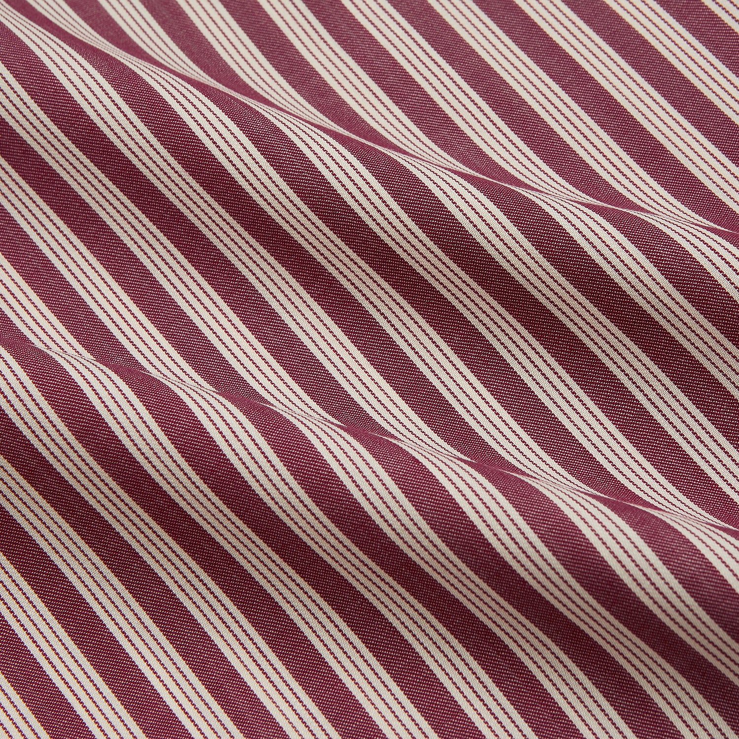 View 4 of product The Turnbull & Asser Burgundy Multi Stripe Weekend Fit Wool Shirt features a Derby collar, 1 button cuffs, and vertical red and white stripes, ideal for casual wear, shown against a white background.