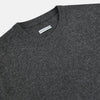 View 2 of product The Turnbull & Asser Charcoal Grey Cashmere Round Neck Jumper features a crew neck, long sleeves, and ribbed cuffs, collar, and hem—an essential piece of men’s knitwear displayed on a white background.
