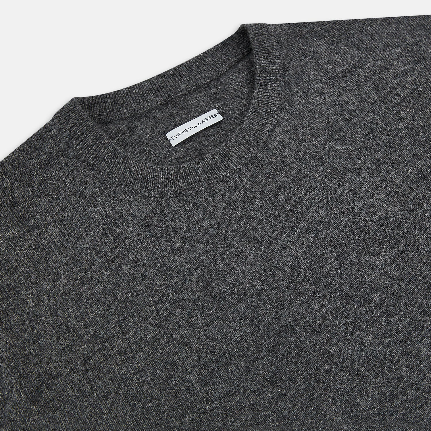 View 2 of product The Turnbull & Asser Charcoal Grey Cashmere Round Neck Jumper features a crew neck, long sleeves, and ribbed cuffs, collar, and hem—an essential piece of men’s knitwear displayed on a white background.