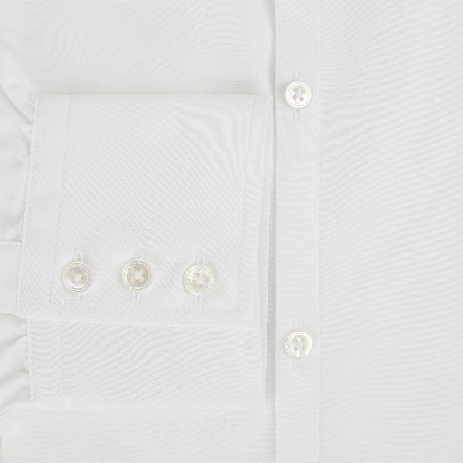 View 4 of product The PLAIN WHITE WESTMINSTER SHIRT WITH TURNBULL COLLAR AND 3-BUTTON CUFFS by Turnbull & Asser features refined British craftsmanship, long sleeves, a straight hem, and a crisp white design displayed on a plain background.