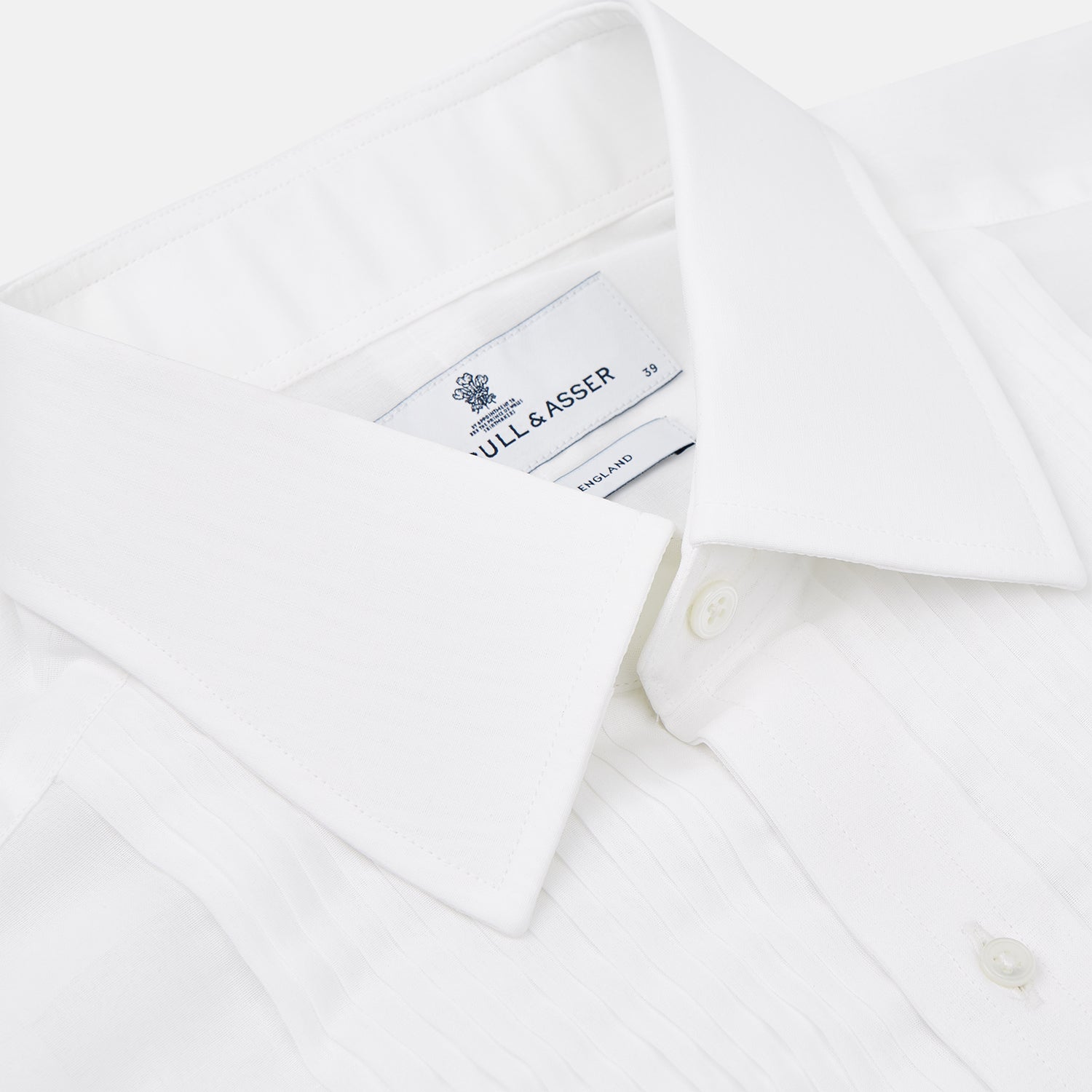 View 8 of product The Die Another Day Inspired Voile Dress Shirt by Turnbull & Asser features a white pleated front, button-down closure, and classic collar—laid flat on white to showcase its timeless James Bond style.