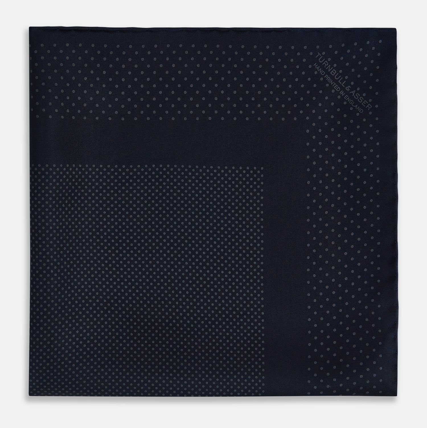View 4 of product The Turnbull & Asser Navy and Charcoal Dot Silk Pocket Square features a subtle dotted pattern and a folded corner, shown on a white background.