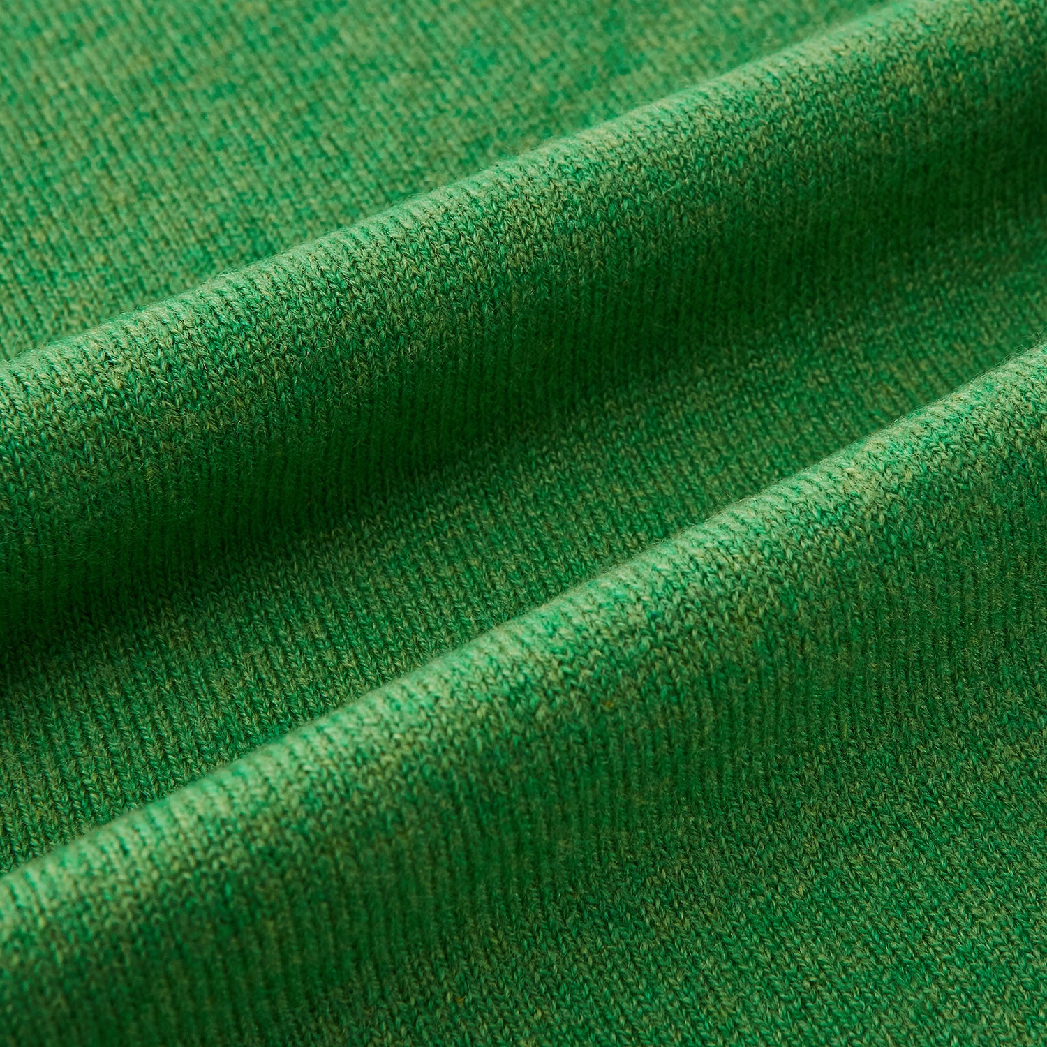 View 3 of product The Turnbull & Asser Plain Kelly Green Cashmere Knitted Scarf is shown looped at the top with both ends hanging down, its soft texture and vibrant color standing out against a plain white background.