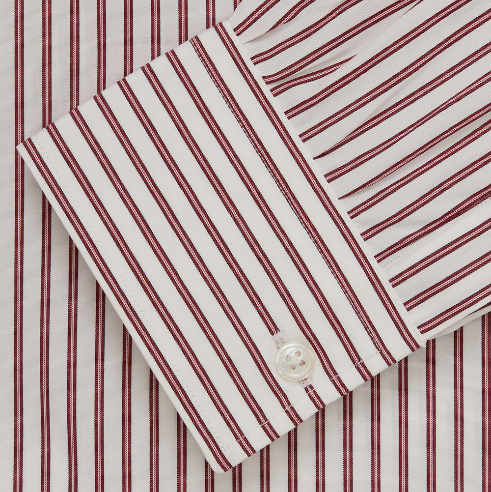 The Turnbull & Asser Burgundy Stripe Weekend Fit Shirt features a Derby collar, 1-button cuffs, and vertical burgundy and white stripes, shown laid flat on a plain light background.