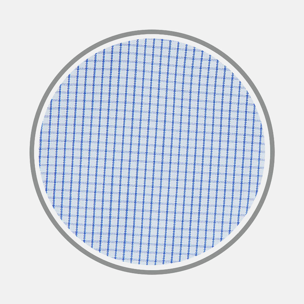 A circular close-up of Turnbull & Asser’s Blue Grid Check Cotton Fabric shows its white base with evenly spaced blue grid lines, bordered by a gray ring on a white background.