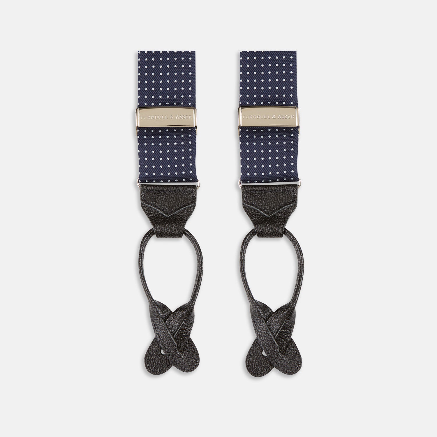 View 4 of product Turnbull & Asser Navy & White Small Spot Adjustable Silk Braces feature black leather loops and silver clasps—timeless accessories displayed on a white background.