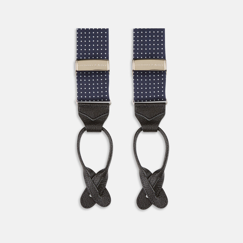 Turnbull & Asser Navy & White Small Spot Adjustable Silk Braces feature black leather loops and silver clasps—timeless accessories displayed on a white background.